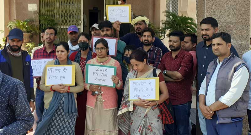 Protest on demand to promote from MPhil to PhD